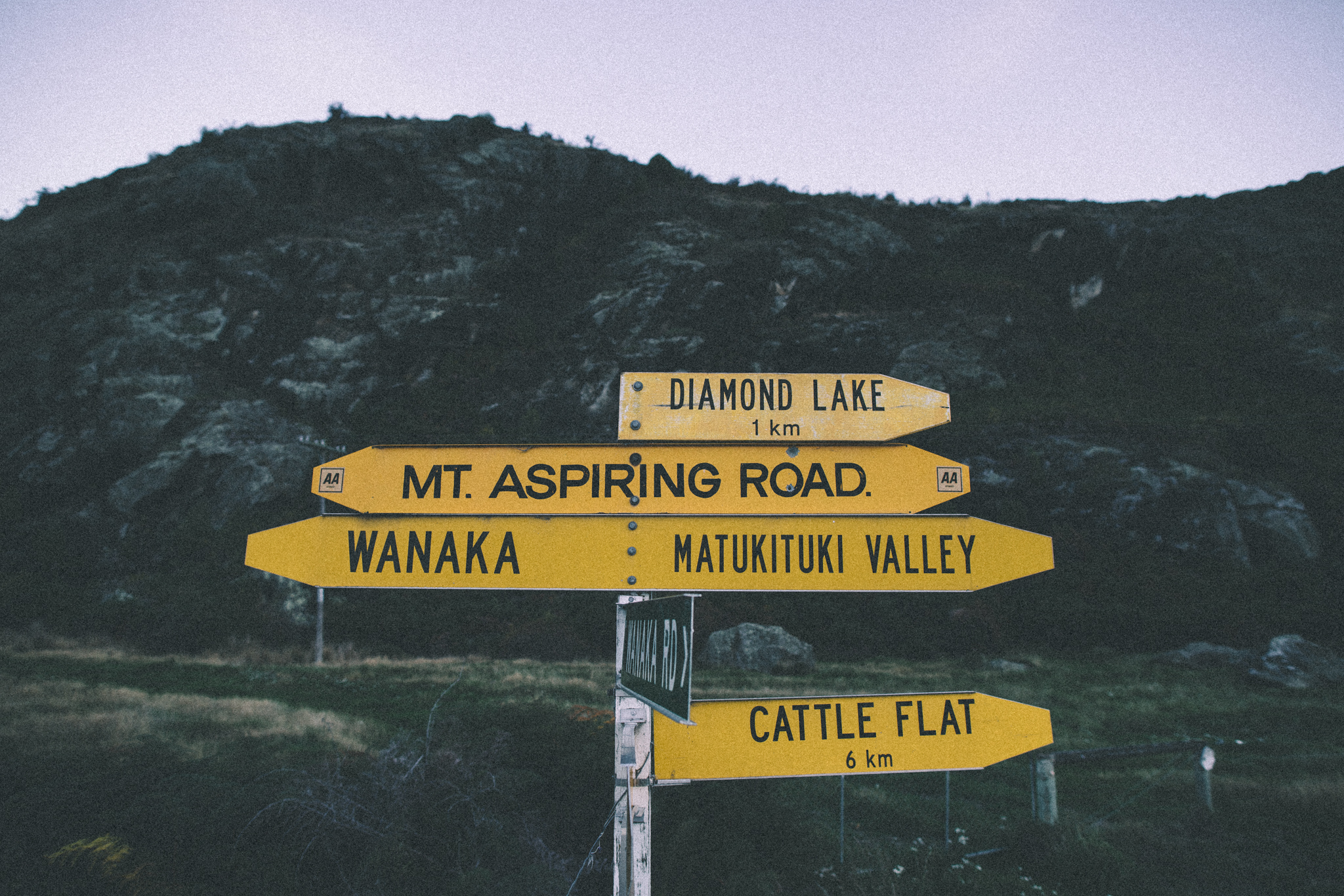 Road signs pointing to different Wanaka location in New Zealand.