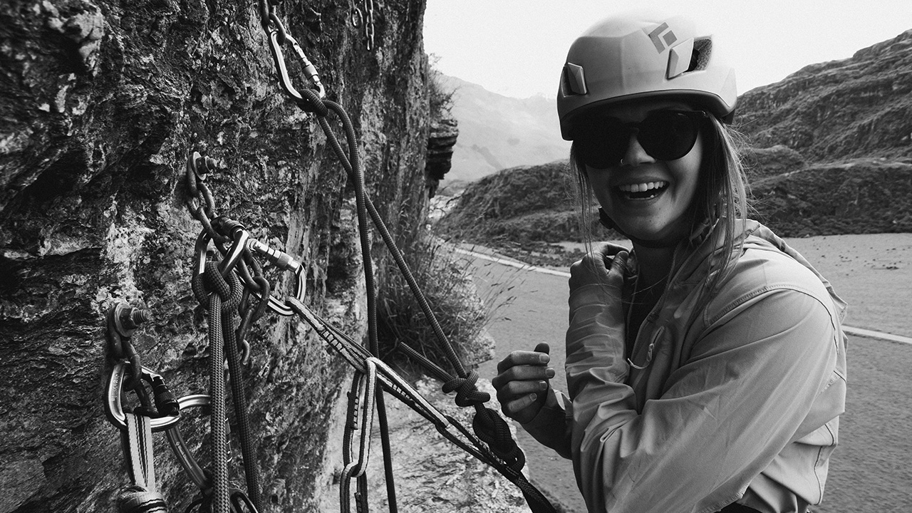 Woman smiling while climbing