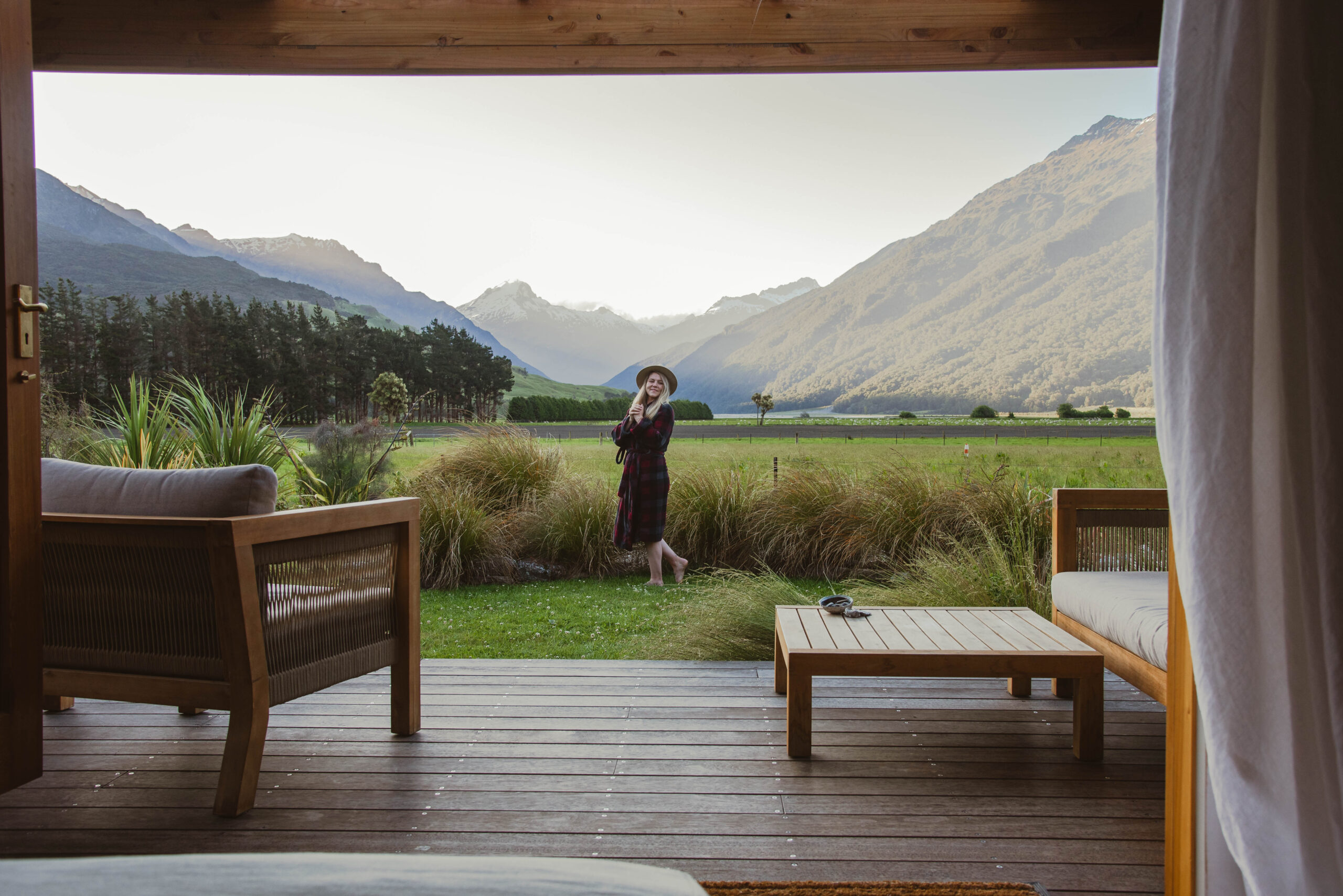 A woman in the yard at Wild Earth Lodge in Makarora, Wanaka region, New Zealand