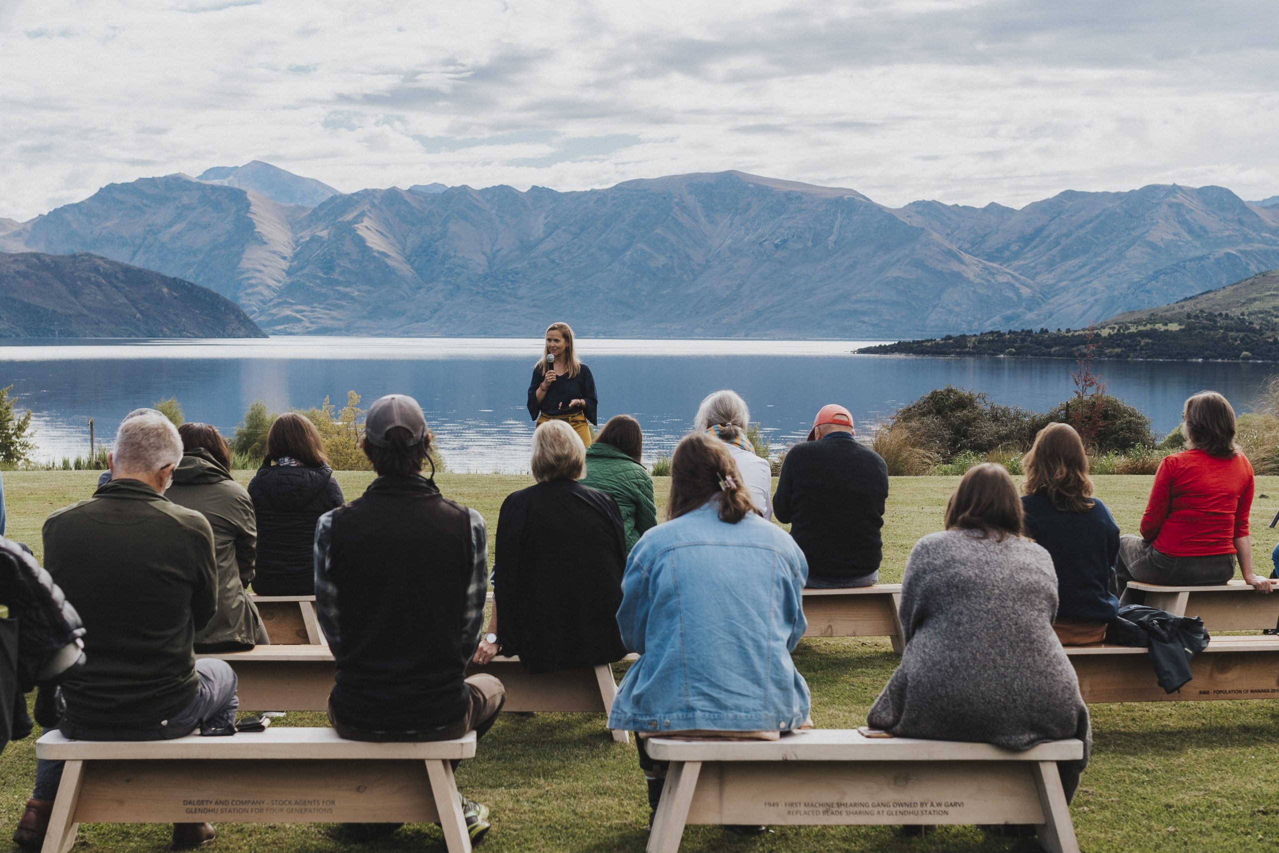 People talking at a community event on the lake